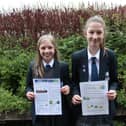 Year 7 pupils Amelia (left) and Leoni with their prize winning work promoting awareness of COP26 and the dangers of climate change.
