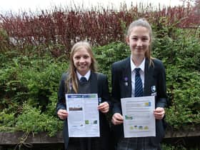 Year 7 pupils Amelia (left) and Leoni with their prize winning work promoting awareness of COP26 and the dangers of climate change.
