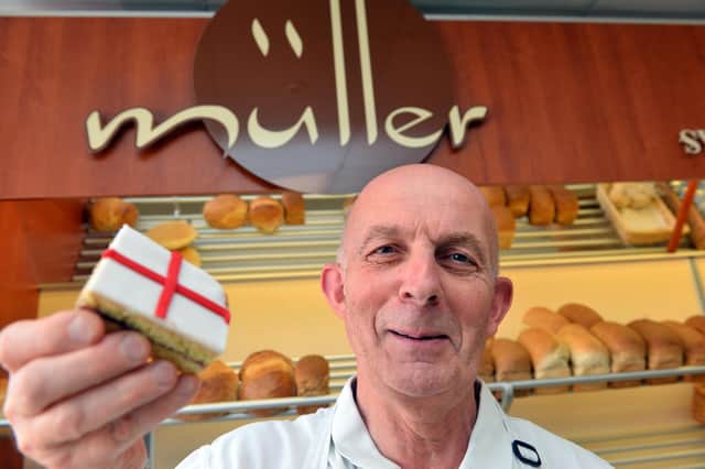 Muller's bakers owner Bruno Muller with the St George's Cross pink slice ahead of the EURO England V Italy final.
