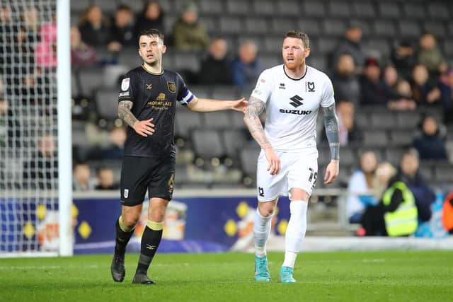 MILTON KEYNES, ENGLAND - APRIL 05: Luke Offord of Crewe Alexandra and Connor Wickham of Milton Keynes Dons look on during the Sky Bet League One match between Milton Keynes Dons and Crewe Alexandra at Stadium mk on April 05, 2022 in Milton Keynes, England. (Photo by Pete Norton/Getty Images)