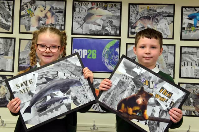 Broadway Junior School Year 3 pupils Rubie Procter, seven and Warren Peverley, eight, with their COP26 posters.