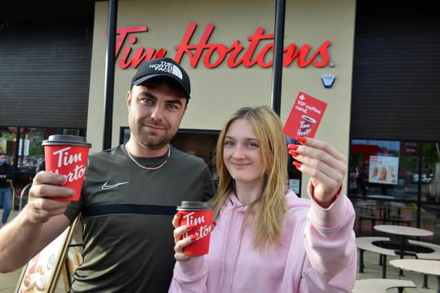 Drive thru first customers Aaliyah Fitzpatrick with partner Chris Donkin receive a one years free coffee VIP voucher at Washington Galleries Tim Hortons.
