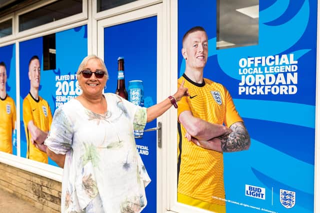 Owner Saima Arif’s at the front of the Seaham store, which has been covered wall-to-wall with Jordan Pickford's face.