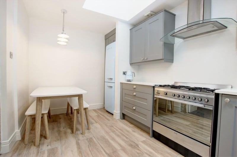 The kitchen is one of a number of rooms to be recently refitted and offers a dining area, with the room kitted out with a range oven and grey base and wall units with contrasting white worktops.