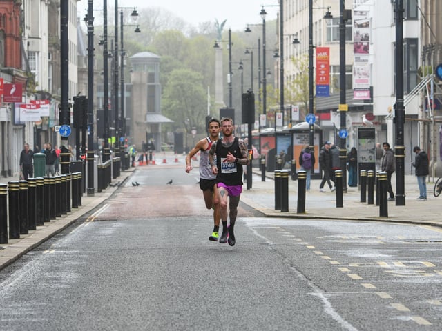 Eventual runner-up Conrad Frank behind the 3rd placed runner Liam Walshaw running along Fawcett Street in Sunderland City Runs 2023 half marathon
