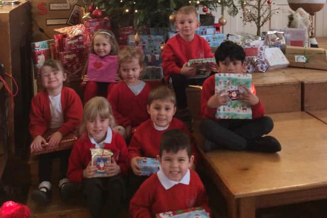 Pupils at Barnes Infant Academy with some of the present they donated