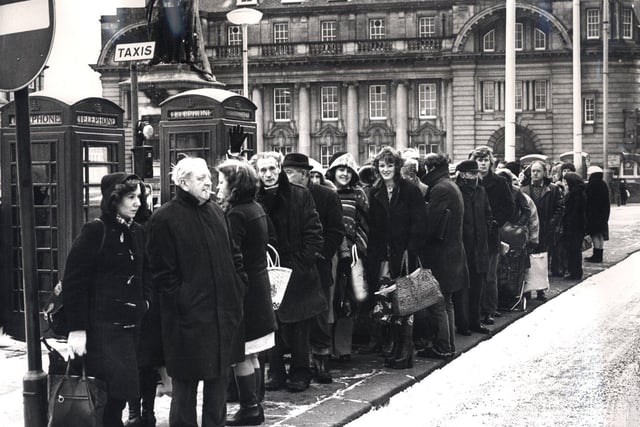 City commuters wait for taxis after the City's buses stopped in February 14, 1979 after the roads weren't gritted