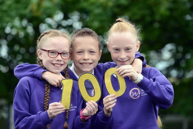 Hasting Hill Academy triplets Imogen, Michael and Milly Laing, five years ago, after achieving 100 per cent attendance at primary school.