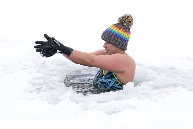 Alice Goodridge plunges through a hole in the ice in Loch Insh, in the Cairngorms National Park.