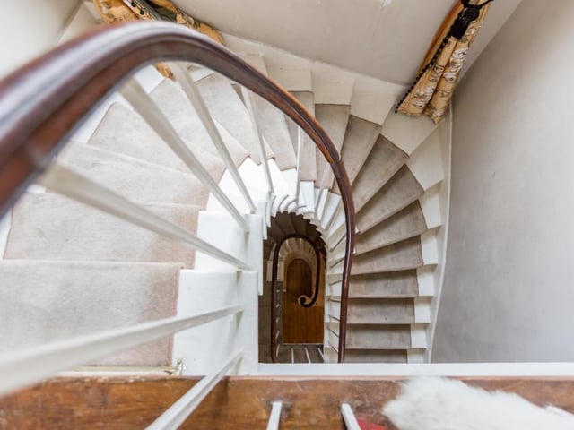 Classic mahogany and stone staircase.