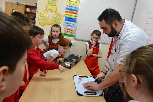 St Paul's CE Primary School pupils get a cooking lesson from The Alexandra Steakhouse chef Geoff Rutherford