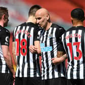 Jonjo Shelvey lines up a wall at Anfield.