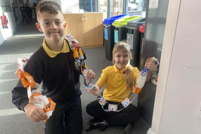 Fatfield Academy pupils Lewis Goodings and Emma Hignett finishing off their Eco Day display using recycled plastics.

Picture by Frank Reid.