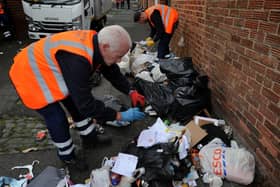 Enforcement officers investigating dumped rubbish.
