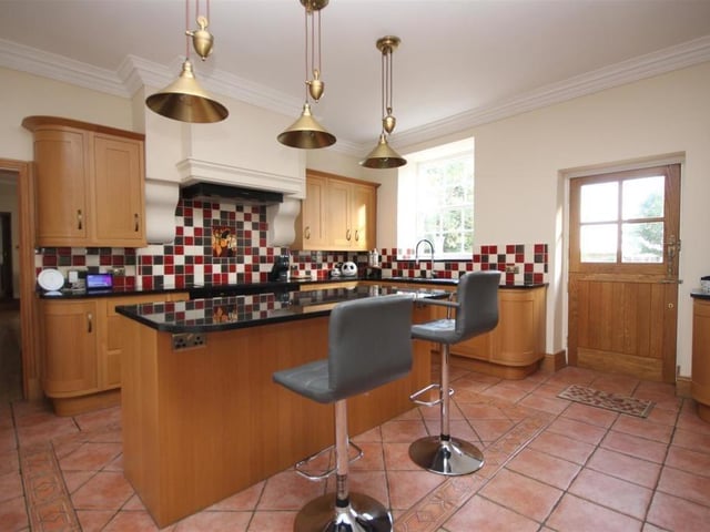 Natural light floods into this room from windows to the front and rear elevations and stable style doors open to provide access to both the rear gardens and to the courtyard at the front.