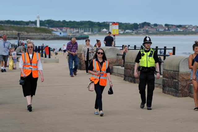 Sunderland City Council enforcement officer Marina Hallam and Natalie Moore, with PC Martin Smith, at Roker Beach.