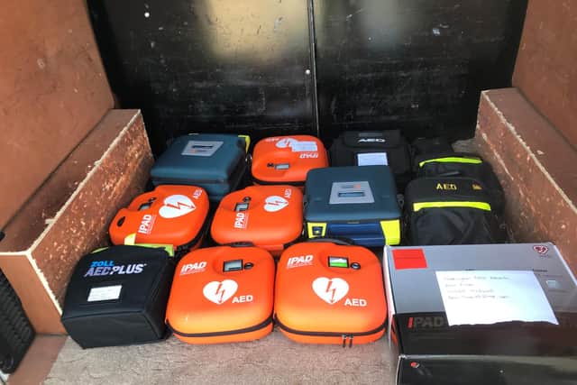 Twelve defibrillators have been handed over to the NHS by football hubs and teams following a call for support.