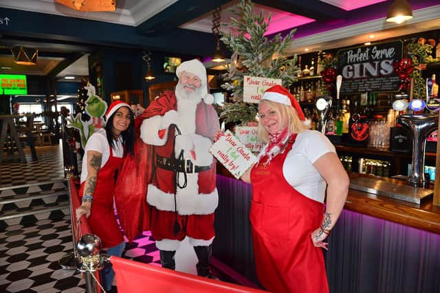Vesta Tilleys bar staff Paula Leighton (left) and Anthea Perry decorate the Christmas Tree. Picture by FRANK REID