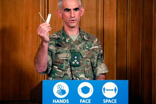 British Army Brigadier Joe Fossey, who is coordinating the mass coronavirus testing pilot in Liverpool, holds up the components of a lateral flow Covid-19 test as he speaks during a virtual press conference on the coronavirus pandemic in the UK inside 10 Downing Street in central London on November 9, 2020. (Photo by Tolga Akmen / POOL / AFP) (Photo by TOLGA AKMEN/POOL/AFP via Getty Images)
