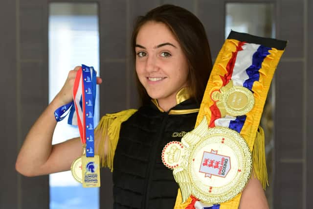 Ella Lonsdale, 15, with her England Junior Female Boxing title belt and her medal for winning the European Junior Boxing Championship for her weight division.