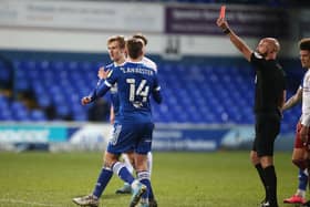 Flynn Downes of Ipswich Town is shown a red card by referee Darren Drysdale during the Sky Bet League One match between Ipswich Town and Northampton Town.