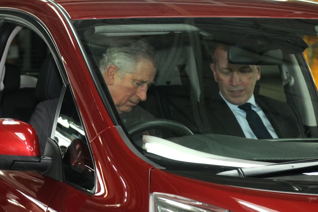 Prince Charles tries out a vehicle on a visit to the Nissan car factory in 2015.