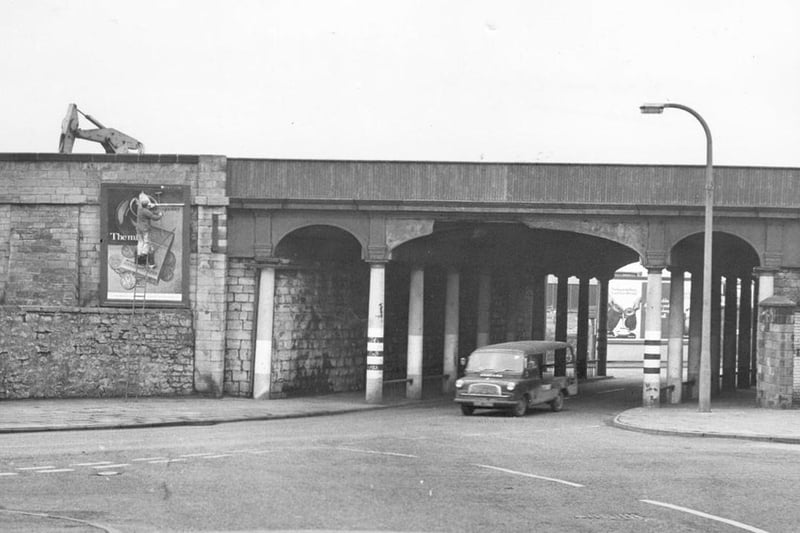 A bill poster busy at work posting an advert at the side of Throston bridge in 1973.
