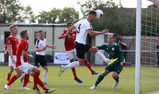 Jake Cooper of Gateshead scores the first goal during the Vanarama National League North Play-Off match between Brackley Town and Gateshead.
