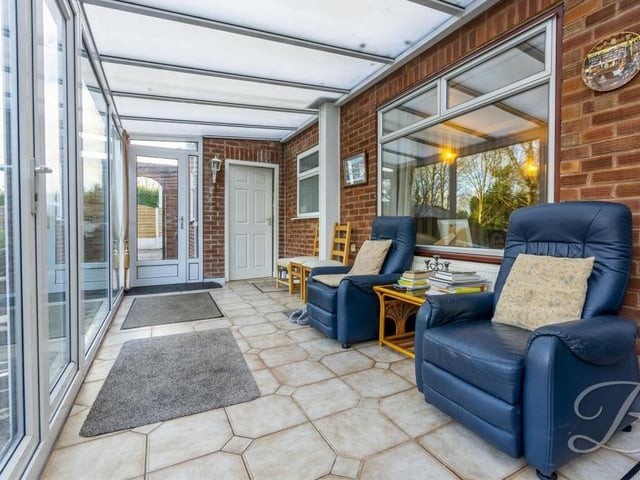 The lengthy and spacious conservatory sits at the back of the Oak Tree Lane property. Its windows overlook the gardens, while patio doors lead out to the back garden.