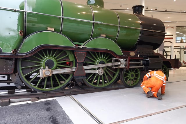 A workman watches closely a engine number 251 arrives in the Doncaster museum