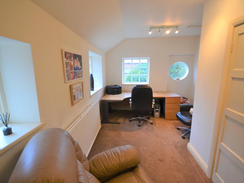 The study enjoys wonderful views of the rear garden from a dual-aspect windows and a feature circular window.