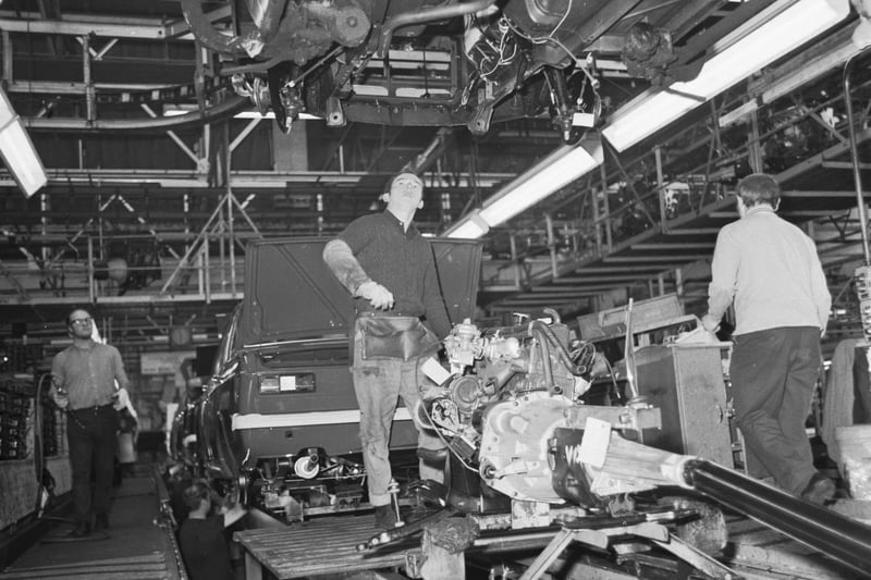 Man working with an engine on the assembly line at the Rootes car plant at Linwood in December 1971.