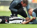 Joe Willock of Newcastle United receives medical treatment after colliding with Vicente Guaita of Crystal Palace (not pictured), leading to a VAR decision to rule out a Newcastle United goal during the Premier League match between Newcastle United and Crystal Palace at St. James Park on September 03, 2022 in Newcastle upon Tyne, England. (Photo by Jan Kruger/Getty Images)