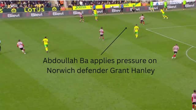 Abdoullah Ba pressing Norwich defender Grant Hanley, who kicks the ball out of play when under pressure.