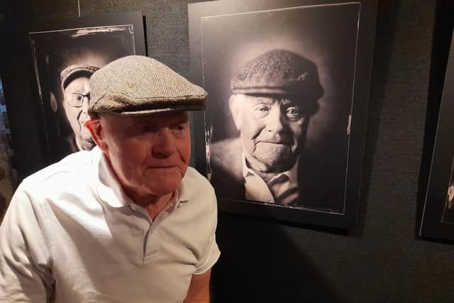Proud miner Alan Taitley, 91, who attended the opening of the exhibition with his family, seen here next to his portrait. Sunderland Echo image.