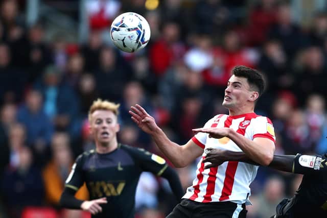 LINCOLN, ENGLAND - OCTOBER 16: Regan Poole of Lincoln City scores their side's second goal during the Sky Bet League One match between Lincoln City and Charlton Athletic at LNER Stadium on October 16, 2021 in Lincoln, England. (Photo by George Wood/Getty Images)