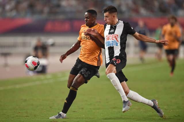 Newcastle United's Kelland Watts (R) fights for the ball with Wolverhampton Wanderers's Niall Ennis (R) during the 2019 Premier League Asia Trophy football tournament in Nanjing, in China's Jiangsu province on July 17, 2019.