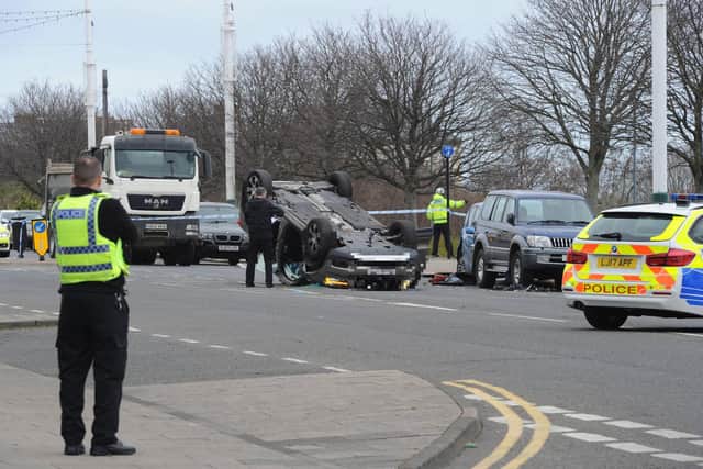 Police cordon off the area where a car lies overturned near The Wolsley pub in Sunderland following an accident this morning leading to a man being taken to hospital with serious injuries.