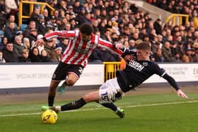 Iliman Ndiaye of Sheffield United is challenged by Charlie Cresswell of Millwall. (Photo by Warren Little/Getty Images).