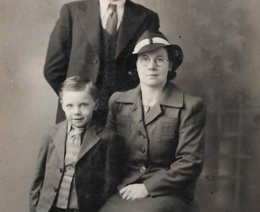 George pictured with his mum Mamie and dad, also called George.