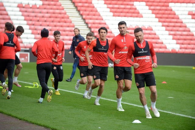 Corry Evans leads his team-mates through the warm-up.