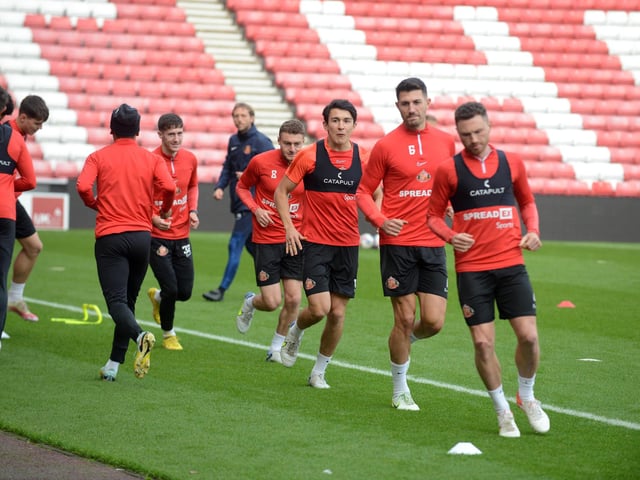 Corry Evans leads his team-mates through the warm-up.