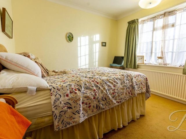 All three bedrooms are well presented, particularly this second one, which has a carpeted floor and a window to the side of the bungalow