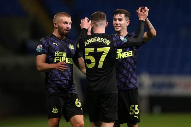 Elliot Anderson celebrates scoring a Papa John's Trophy goal for Newcastle United.