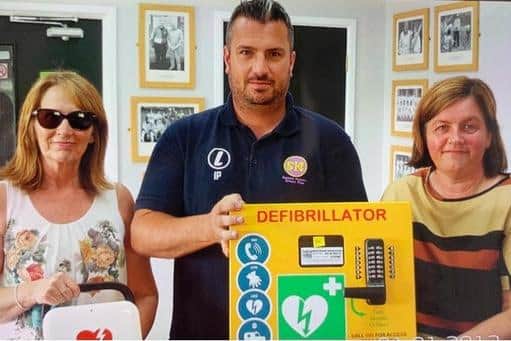 Yorkshire Three Peak conquerors Alyson Taylor, left and Joanne Crosby with Ian Patterson, vice-chair and team captain of Seaham Harbour Cricket Club with their new defibrillator.