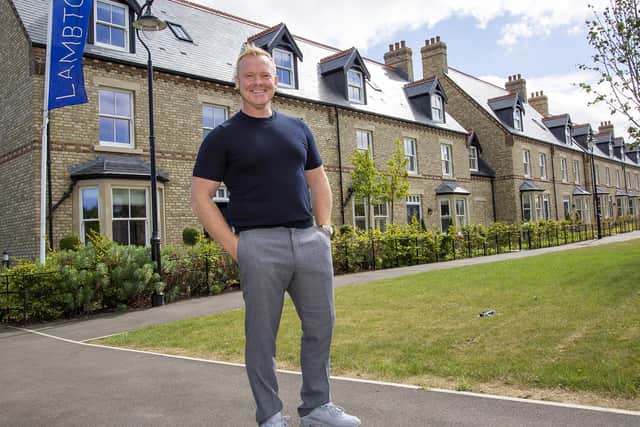 Craig Van Bedaf, who is the architect on the estate, in front of one of the splendid rows of houses.