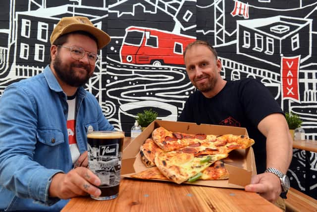 Slice founder Andy Smith, right, is going to be taken over a pizza unit at Vaux. Tap room manager Ethan Foster.