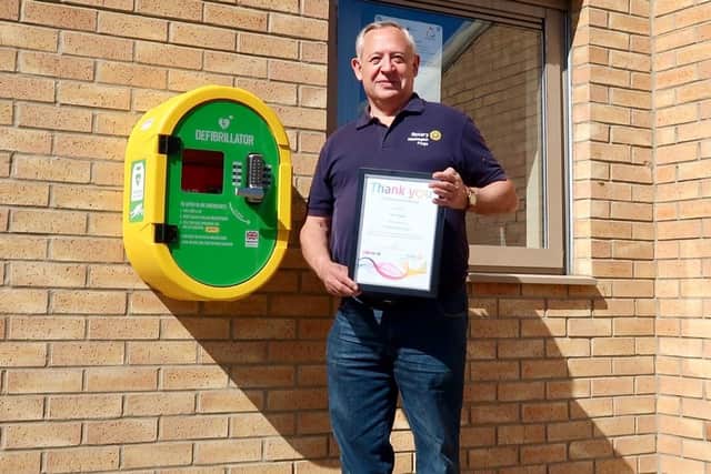 Phil Hopps with one of the defibrillators installed by Rotary North East.
