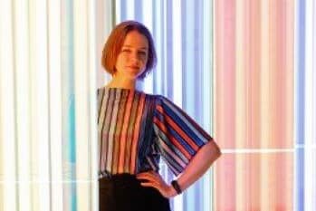 Artist Liz West pictured in front of her artwork, Our Spectral Vision, currently on display at The Light.