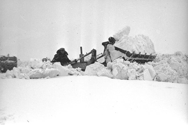 An excavator had to be used to clear a path before a snowplough could tackle the job of shifting this deep snow on the Warden Law to Ryhope Road in 1963.